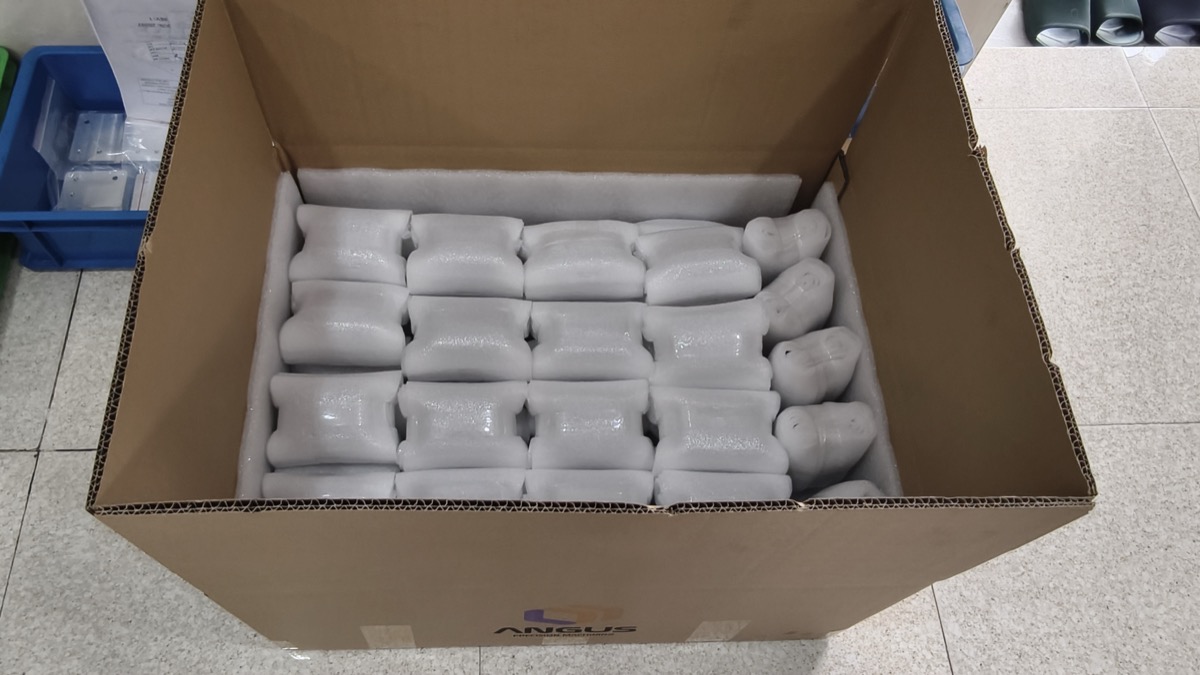 Foam-wrapped CNC machined parts packed in Angus export carton