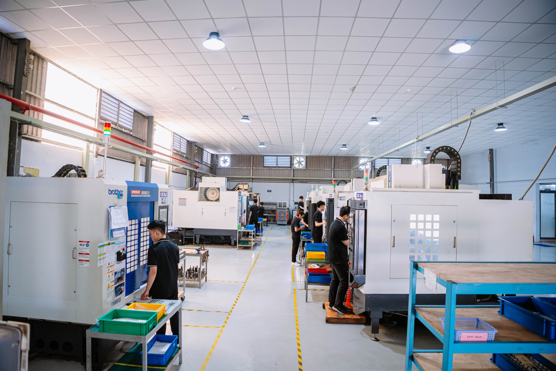 CNC machine operator at console Brother S500X2 3-axis VMC
